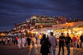People walking around Djemaa El Fna square at dusk Marrakech Mor