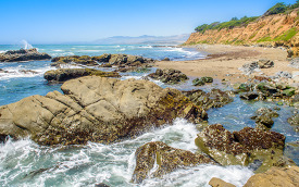 photo waves breaking on rocks california coast
