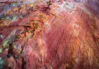 red mineral in rock pattern closeup