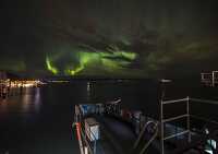 ship moored under northern lights in norway