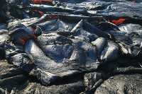 Sluggish pahoehoe briefly spills over a section the levee