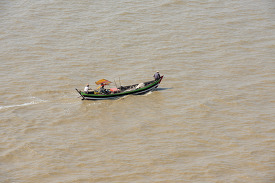 Small fishing boats along the Yangon river Myanmar 