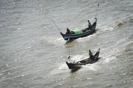 Small fishing boats along the Yangon river Myanmar 