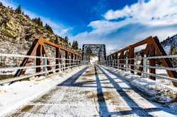 snow covered Pumphouse Road Bridge crosses the Big Hole montana