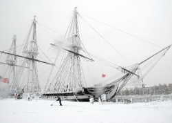 snow in front of uss constitution. constitution is the world's o