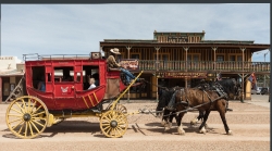 stagecoach driver and horses pause on the streets of tombstone a