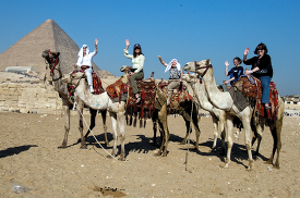 tourist riding camels near pyramids egypt-1775