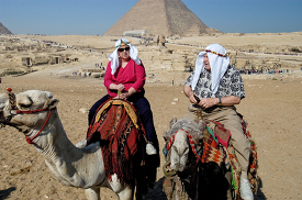 tourist riding camels near pyramids egypt-1780