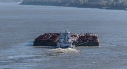 ugboat pushes a wide barge
