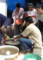 Victims of the devastating tsunami wash their dishes
