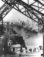 Victory cargo ships are lined up at  west coast shipyard