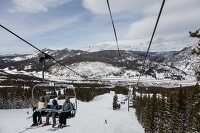 View of chair lift with skiers and snowboarders