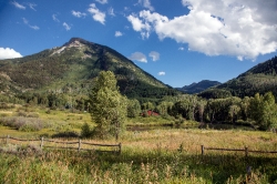 view-of-a-rocky-mountain-peak-and-meadow