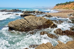 waves breaking on a rocky shoreline sunny day