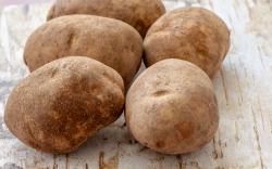 whole potatos on with paper background photo