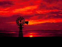 Windmill silhouetted at sunset in eastern Colorado