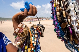 Woman holding beads for sale Goa India
