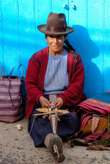woman sitting and weaving goods