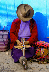 woman sitting and weaving goods in Cuzco
