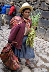 Woman walking along a cobblestone street in peru