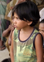young Indonesian child listens about relief aid