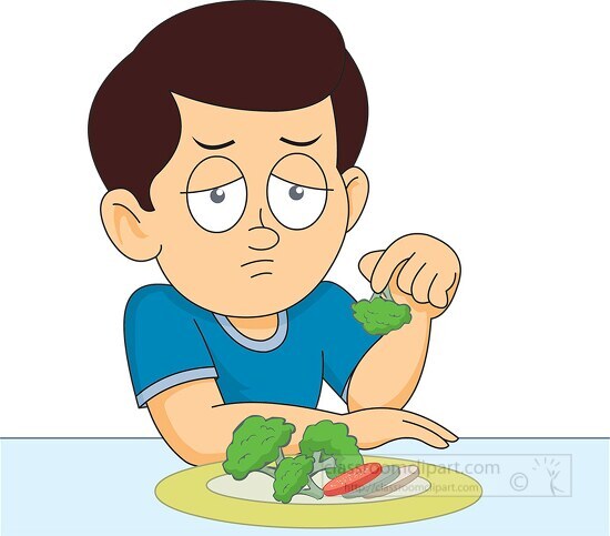 boy showing vegetables from his meal with less interest