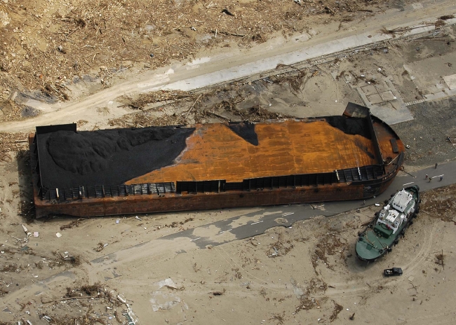 aerial view of two ships that were washed ashore