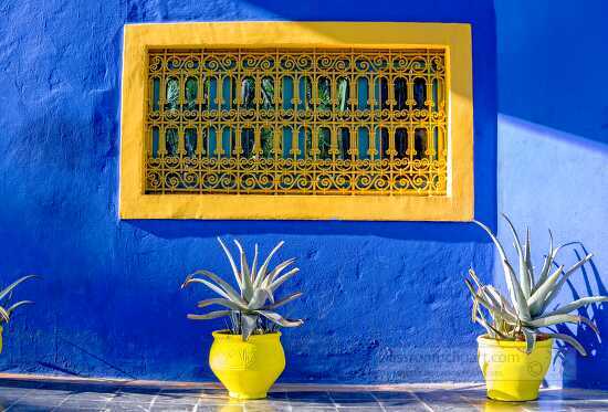 Bright Blue walls with Yellow Window Menara gardens Marrakeh Morocco