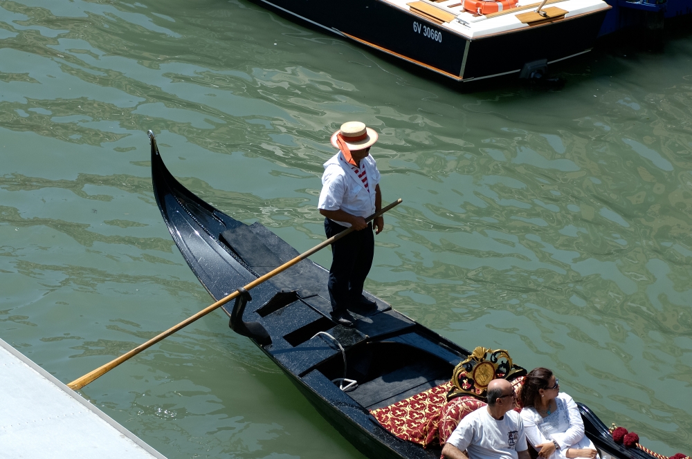 Gondolier on gondola with tourists 1686