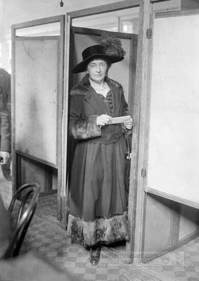 Margaret Lally at the door of a voting booth during the first el