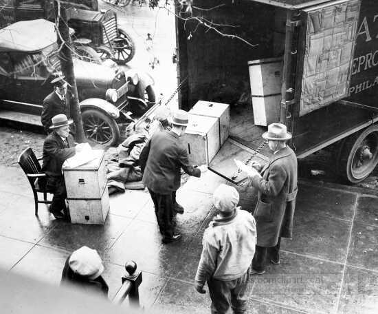 Men removing ballot boxes from enate election from truck at the 