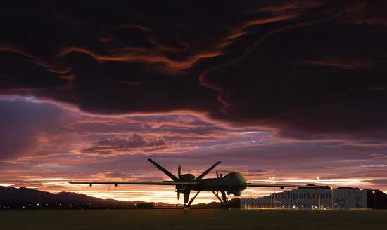 MQ-9 Reaper sits on the flightline as the sun sets
