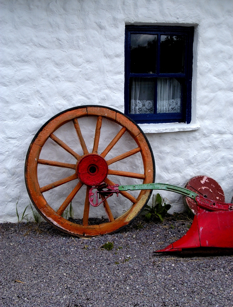 Old Wheel and rustic farm equipment.