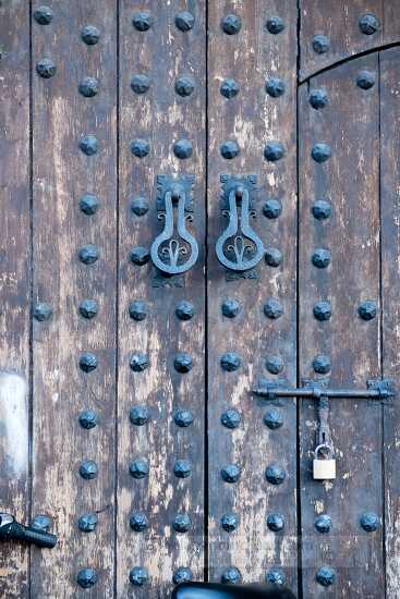 ornate-wooden-door-with-metal-divets
