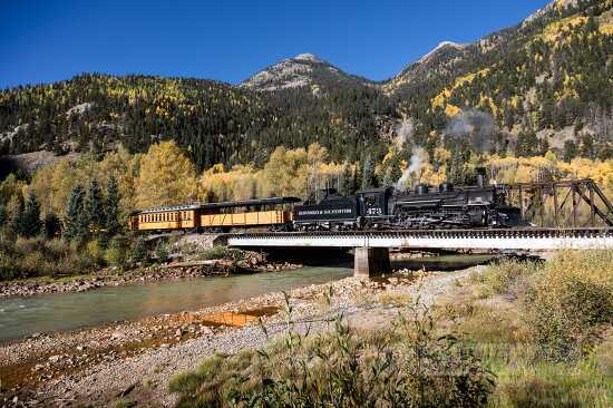 panoramic view of steam train on  trestle bridge 