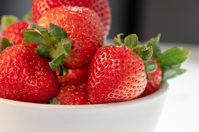 photo image closeup bowl of strawberries on background