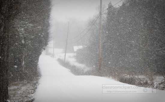 photo of snow falling along a country road tennessee