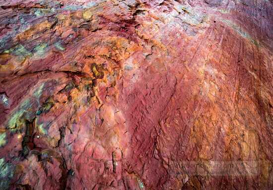red mineral in rock pattern closeup