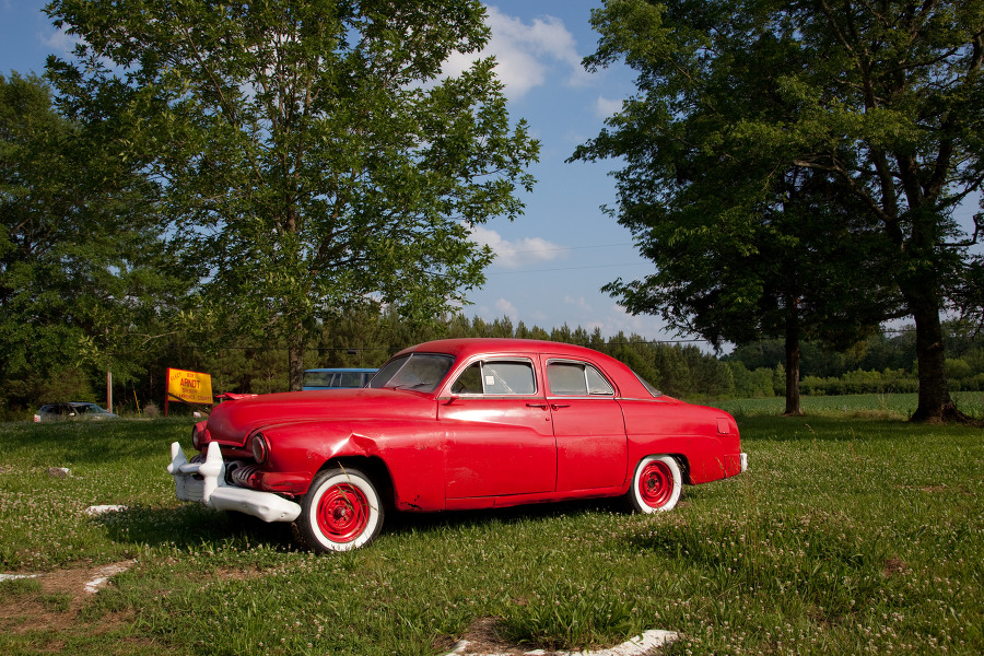 Red painted old car in field near Oakville Alabama