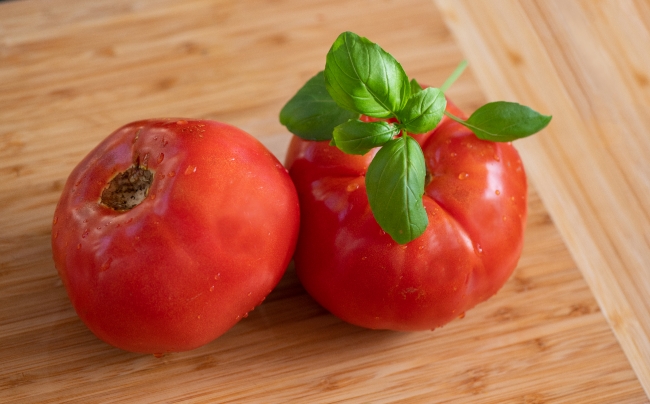 ripe whole tomatoes with fresh basil