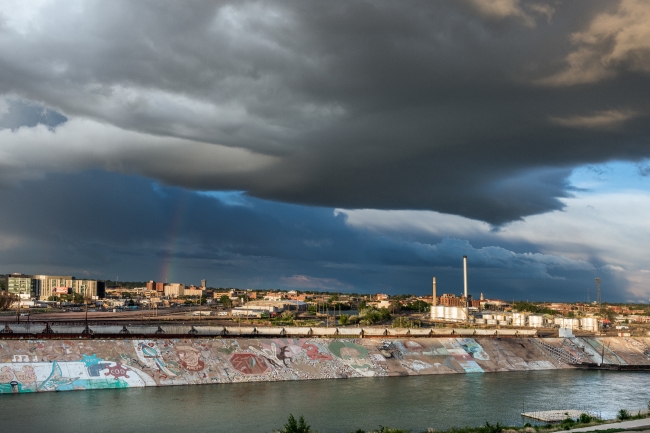roiling-clouds-and-a-rainbow-appear-above-the-skyline-of-pueblo-