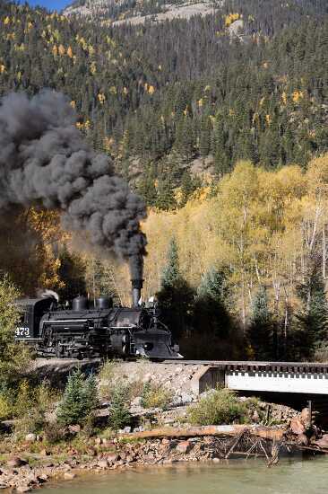 steam train enters a trestle colorado