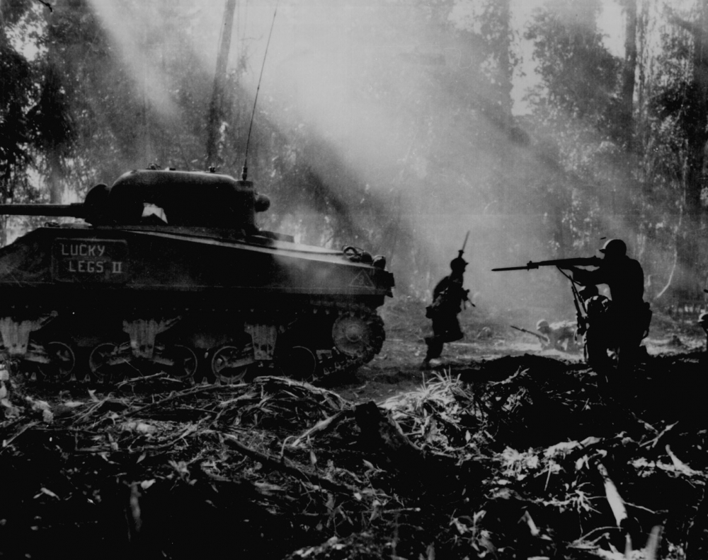 This photo shows tank going forward infantrymen following in its cover