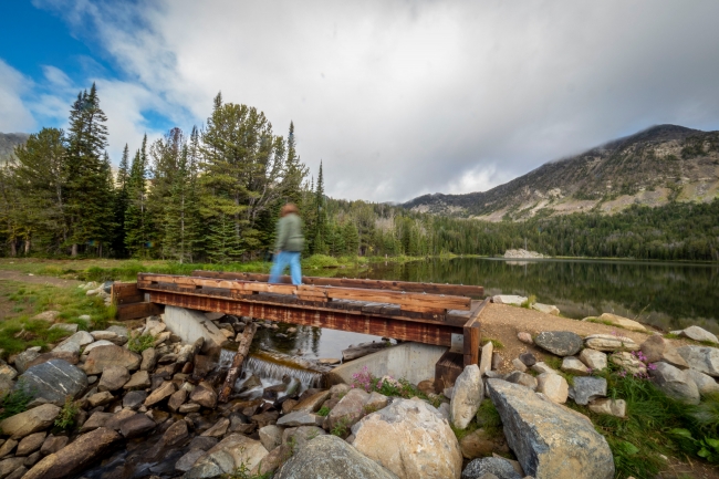 Visitors walking over bridge at branham lakes montana 2