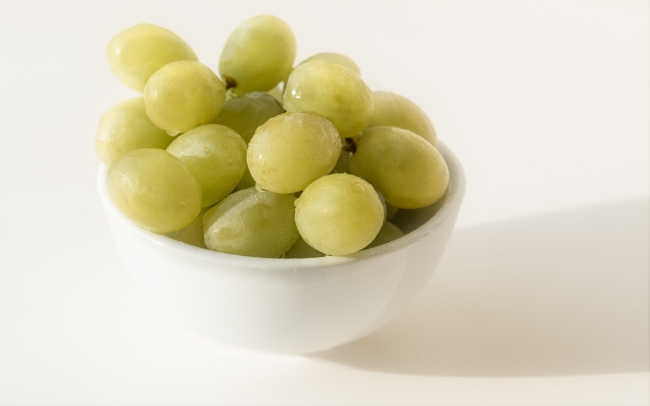White Bowl Filled With Green Grapes Photo