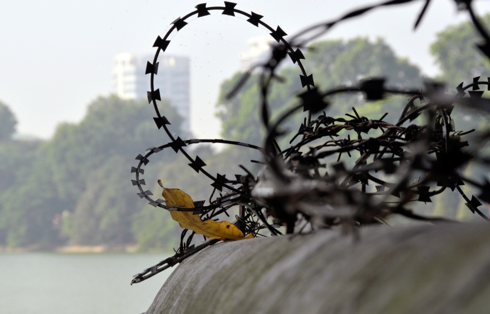 wires on fence Ho Hoan Kiem Lake Hanoi