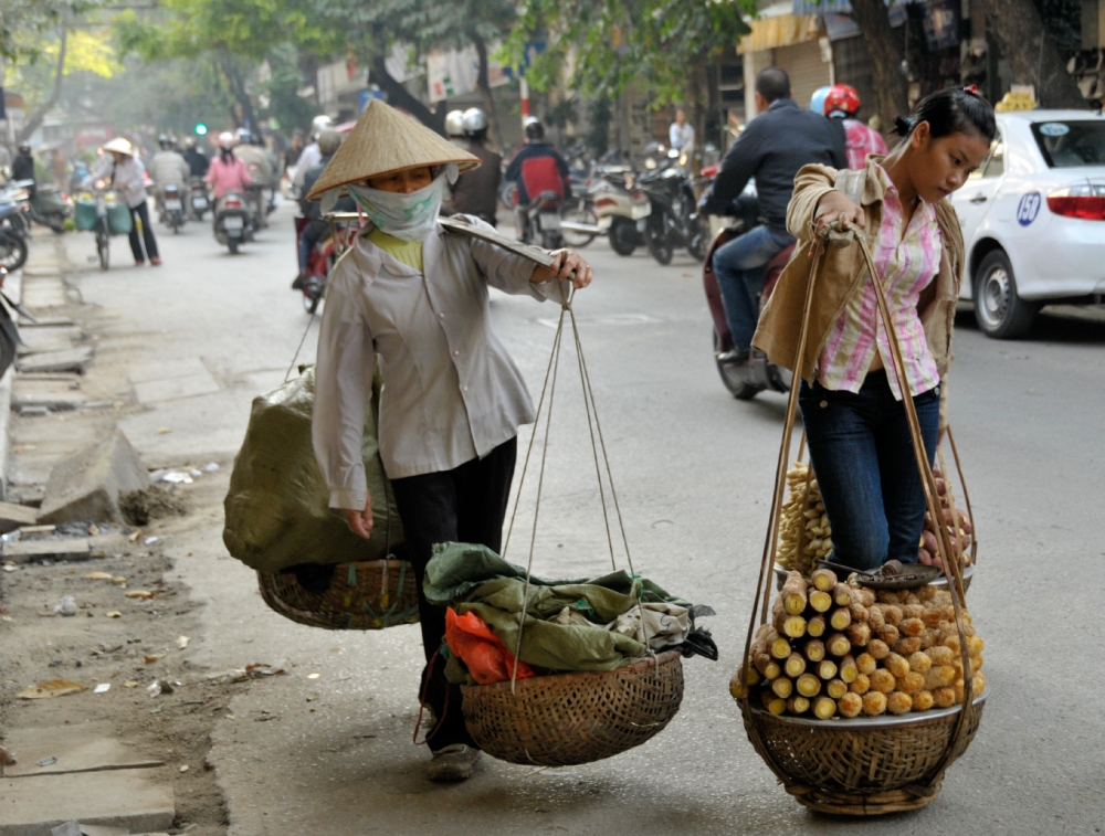 Women walking along street with basket