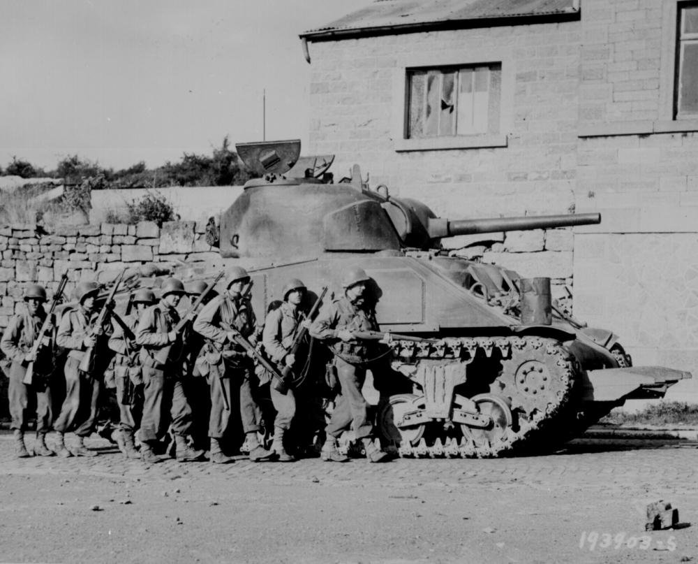 Yanks of 60th Infantry Regiment advance into a Belgian town