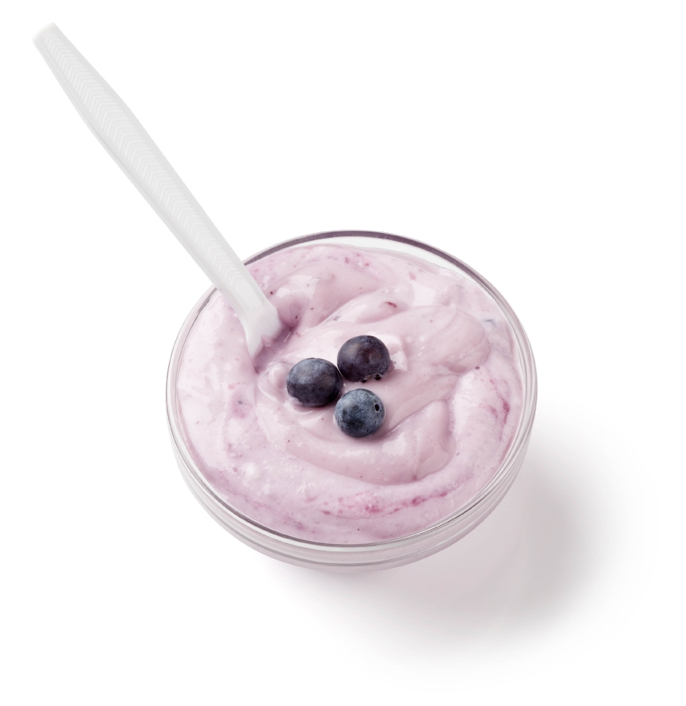yogurt topped with 3 blueberries in clear bowl with spoon