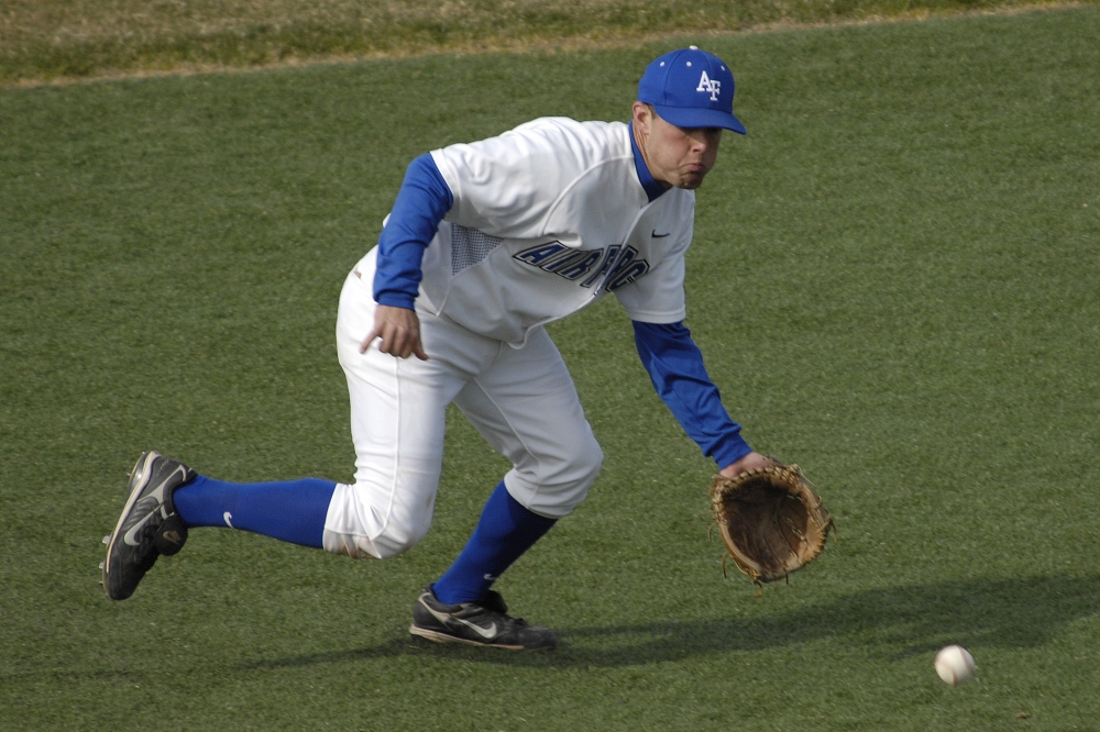 scoops up a ground ball Classroom Clip Art